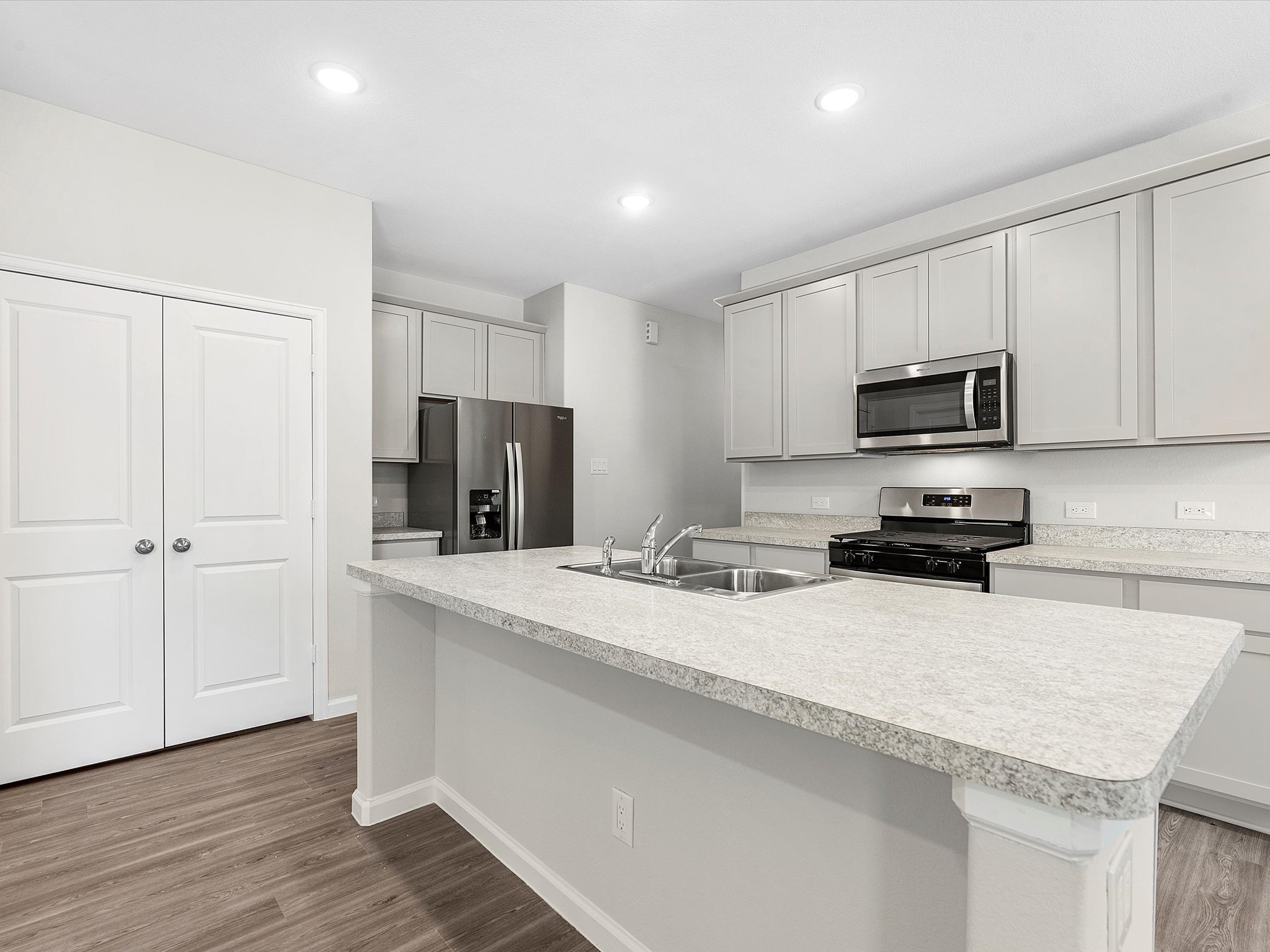 A kitchen with white cabinets.