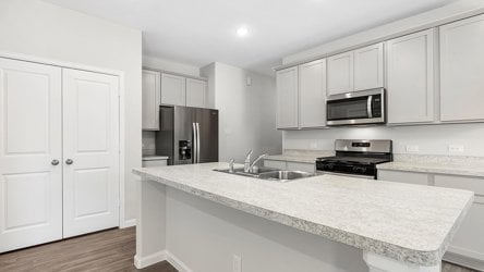 A kitchen with white cabinets.