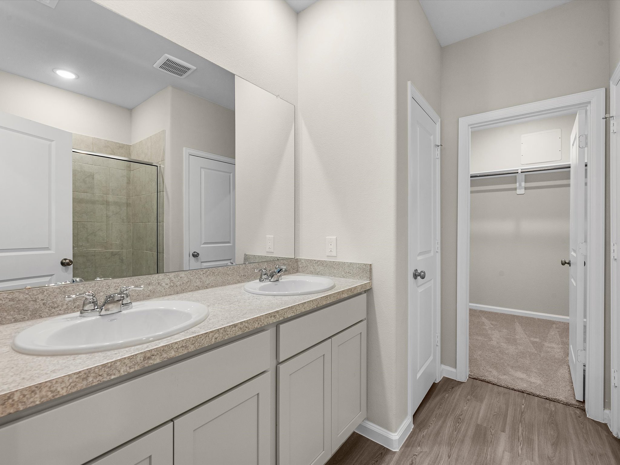 A bathroom with a large mirror.