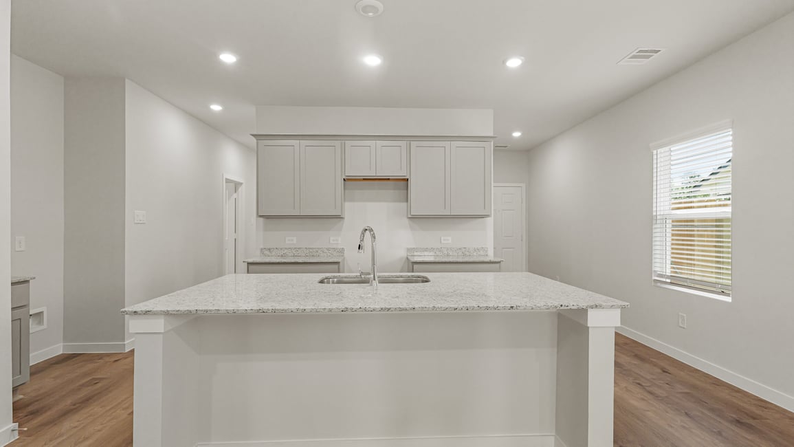 A kitchen with a marble countertop.
