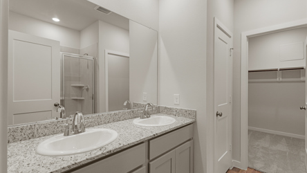 A bathroom with a large mirror.