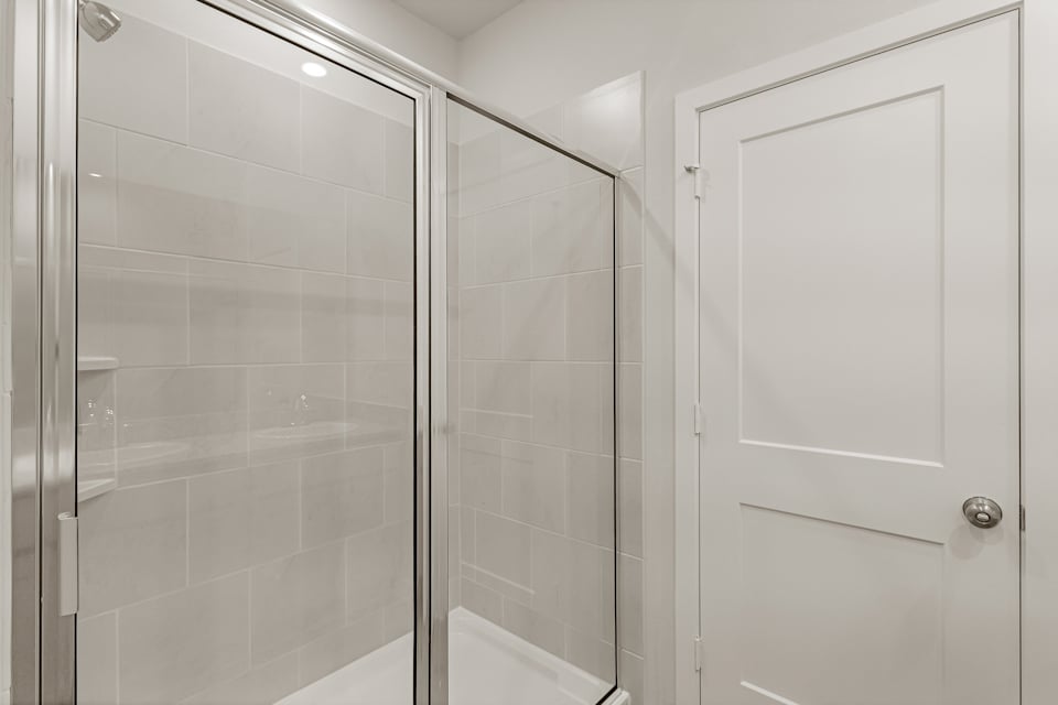 A shower with a glass door.