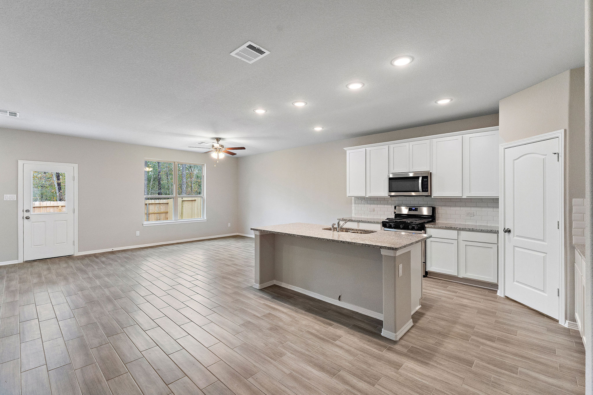 A kitchen with white cabinets.