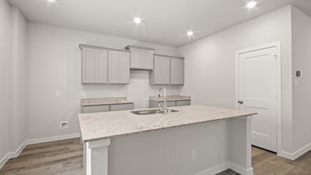 A kitchen with white cabinets.