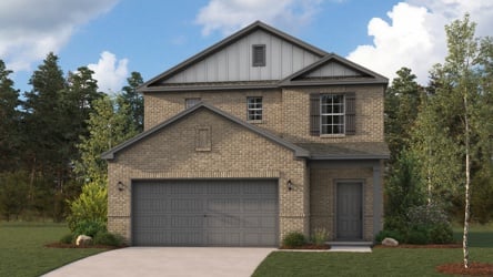 A house with a garage with Orchard House in the background.