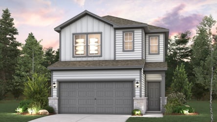 A house with a garage and trees around it.