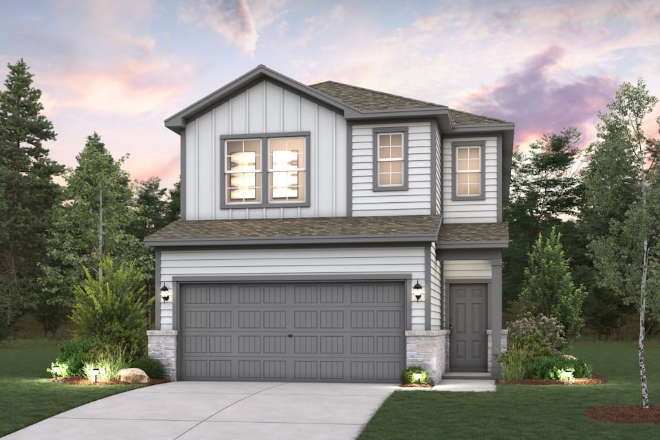 A house with a garage and trees around it.