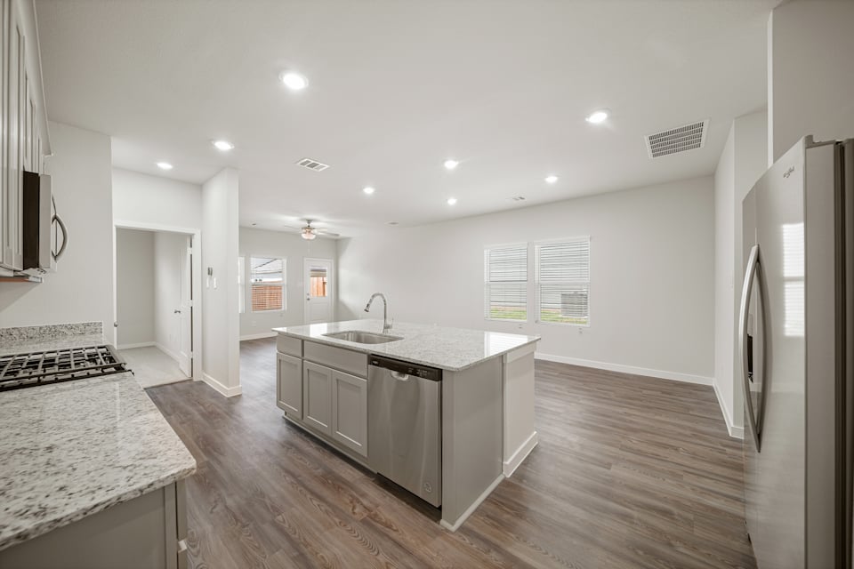 A kitchen with a marble island.