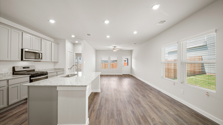 A kitchen with white cabinets.