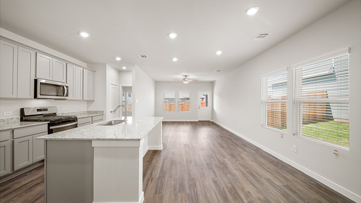 A kitchen with white cabinets.