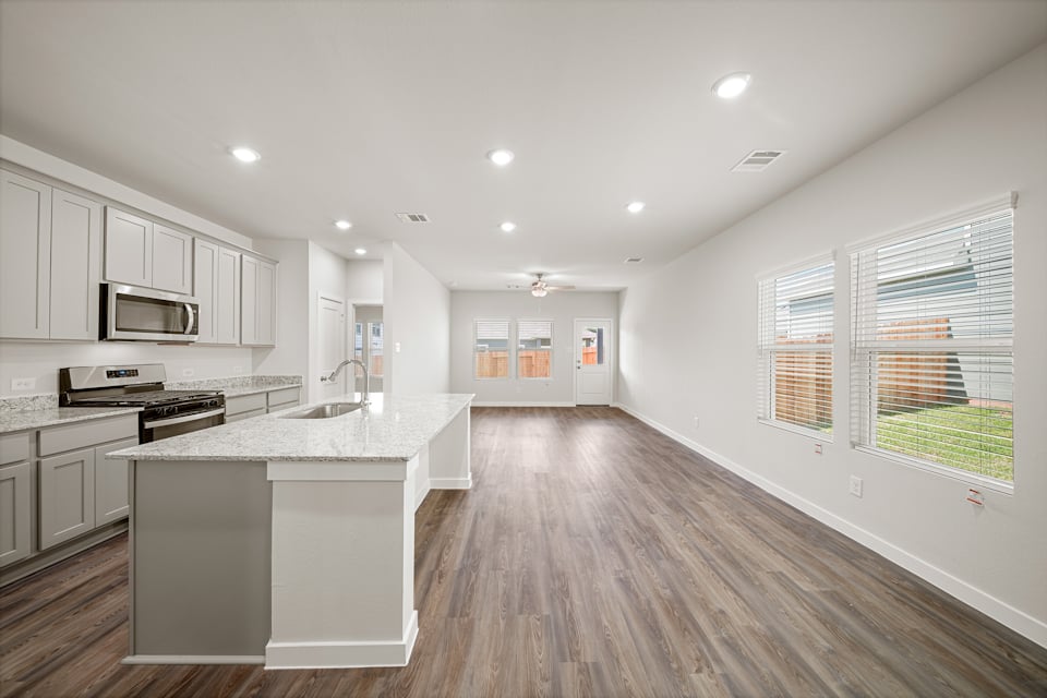 A kitchen with white cabinets.