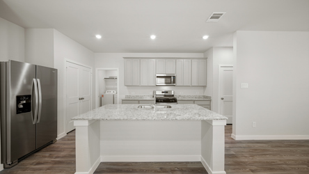 A kitchen with a marble counter.