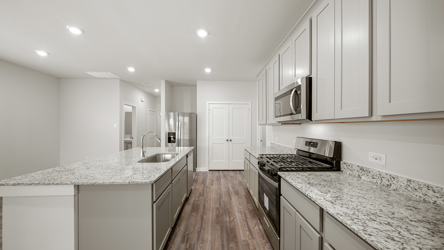 A kitchen with white cabinets.
