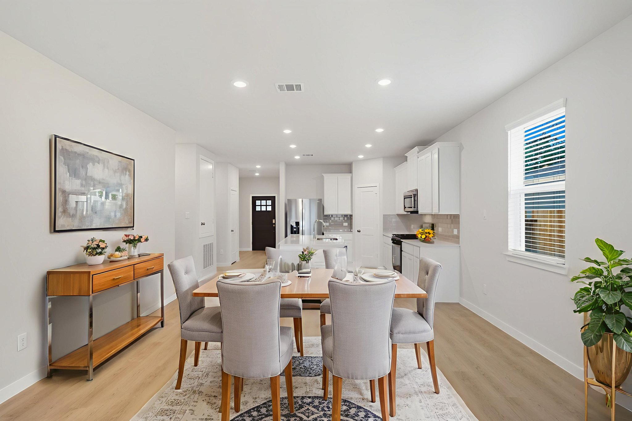 A dining room with a table and chairs.