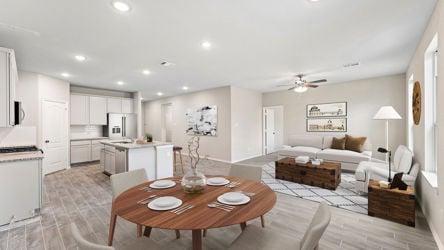 A large living room with a dining table and couches.
