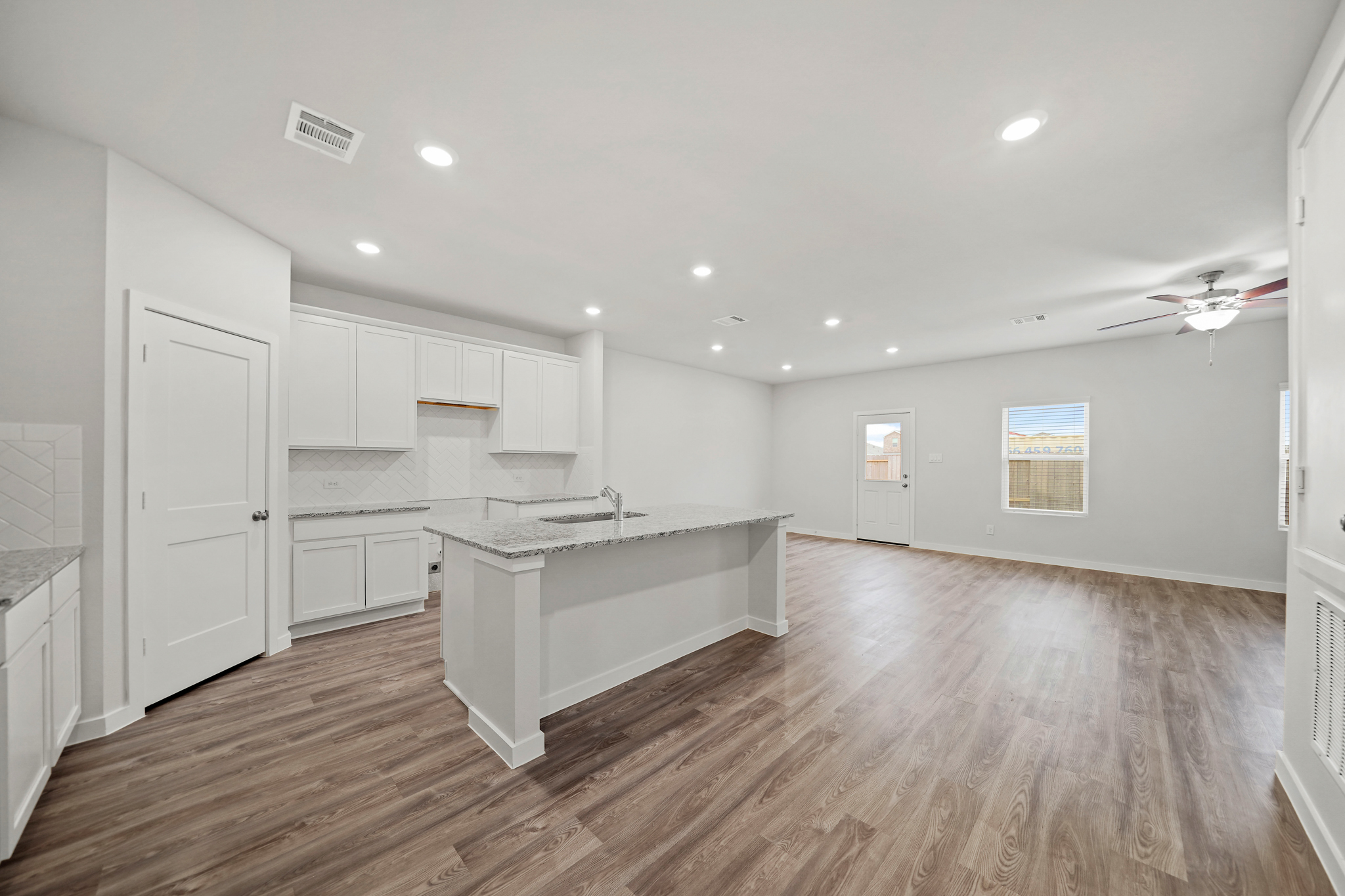 A large kitchen with white cabinets.