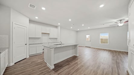 A large kitchen with white cabinets.