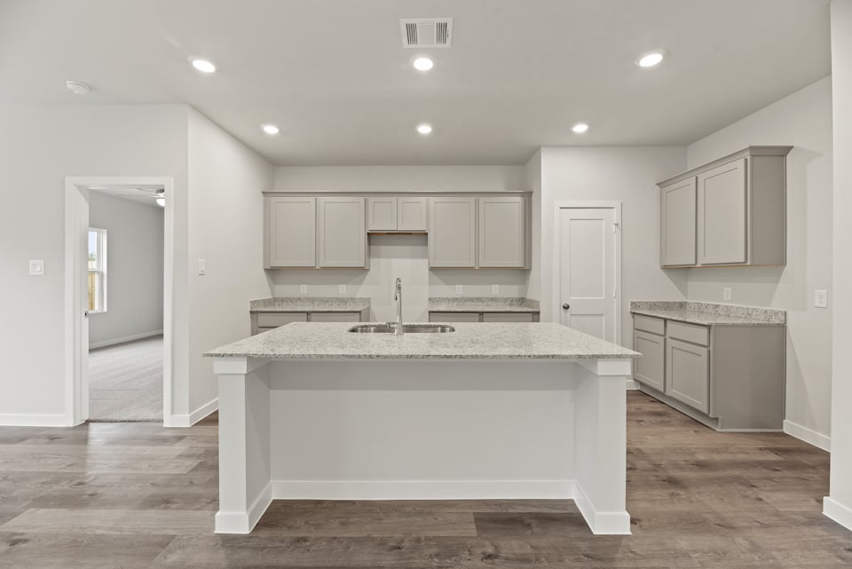 A kitchen with white cabinets.