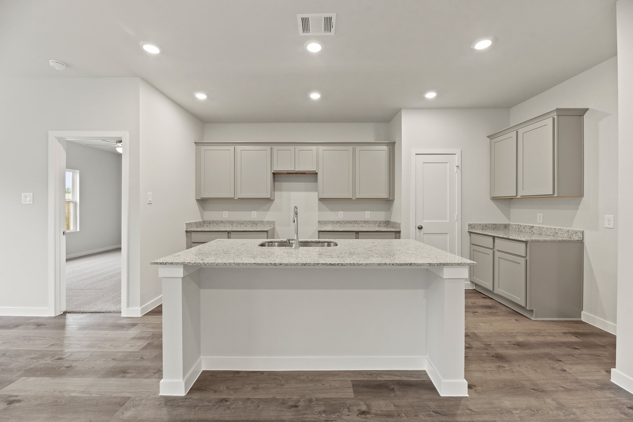 A kitchen with white cabinets.