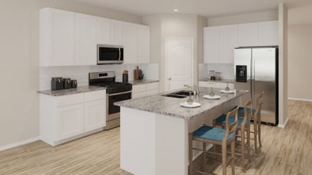 A kitchen with white cabinets.