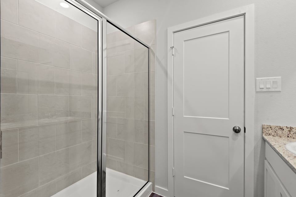 A bathroom with a glass shower.
