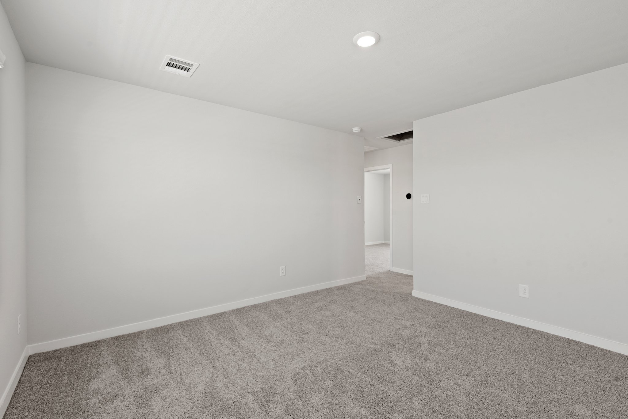 A hallway with white walls.