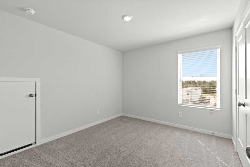 A room with a window and a door.
