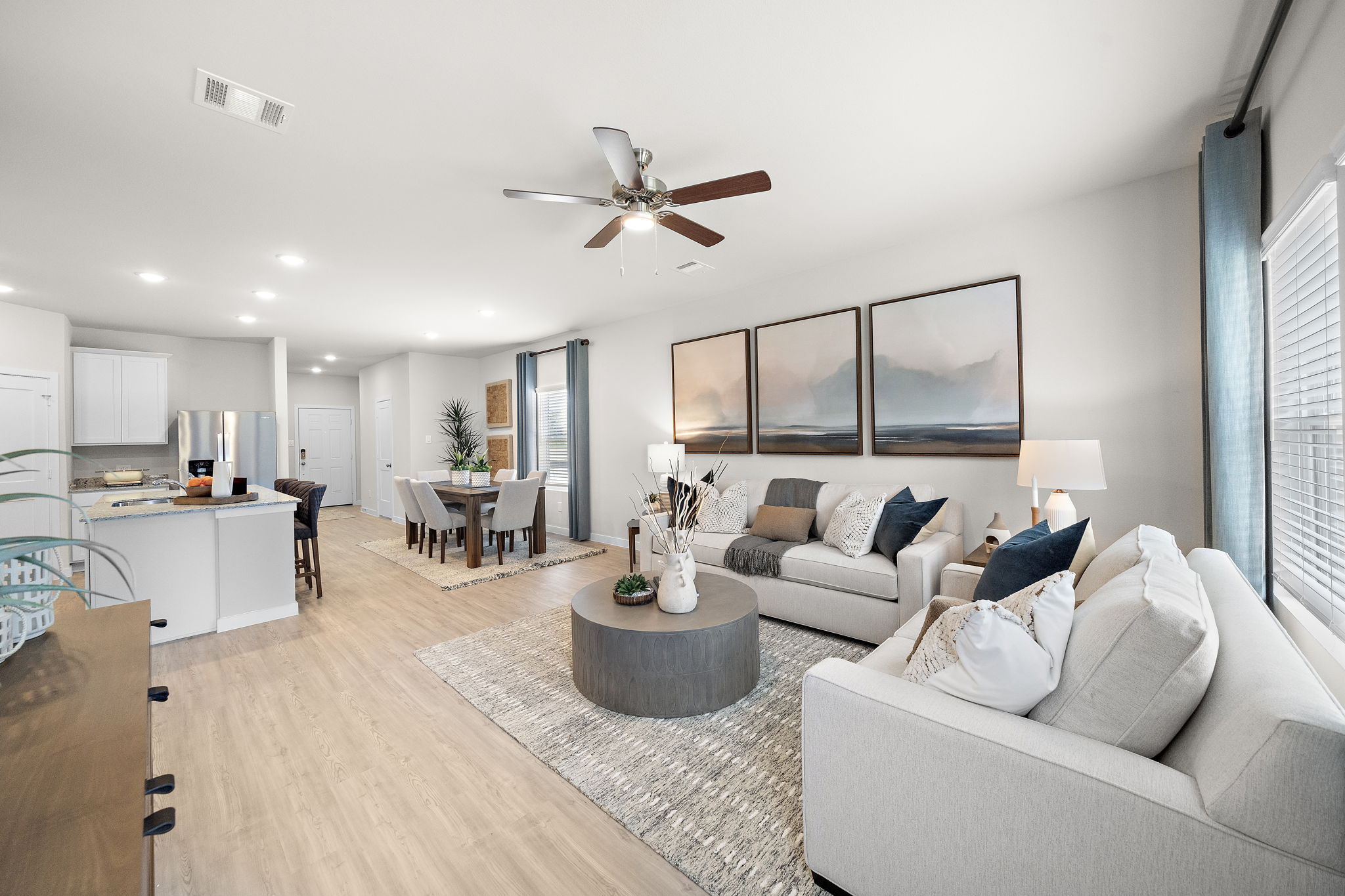 A living room with a large ceiling fan.