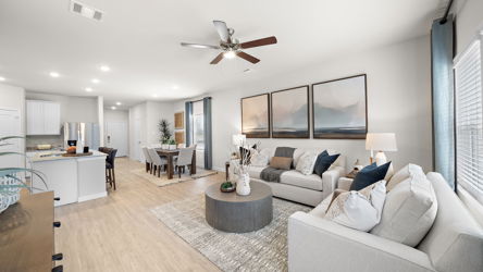 A living room with a large ceiling fan.