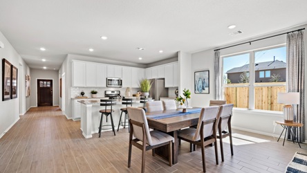 A large kitchen with a dining table.