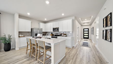 A kitchen with white cabinets.