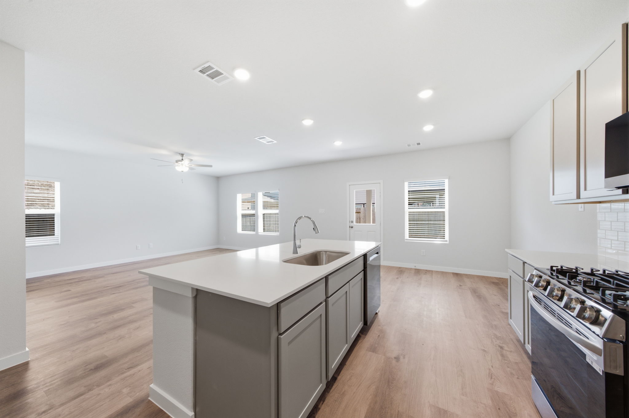 A kitchen with a wood floor.