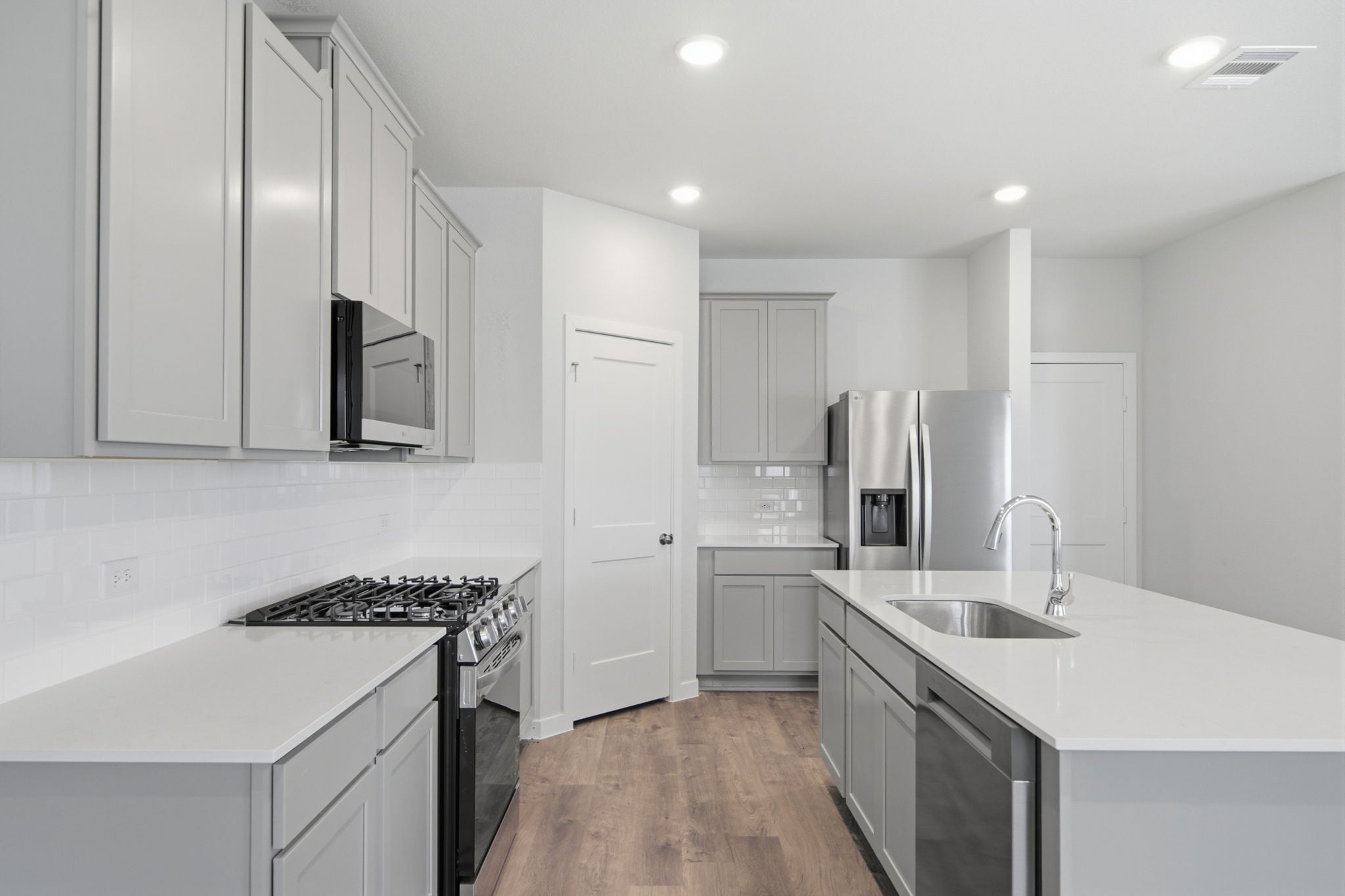 A kitchen with white cabinets.