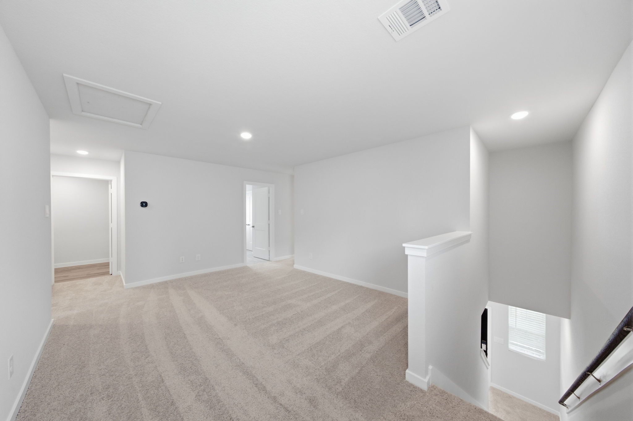 A long hallway with white walls.
