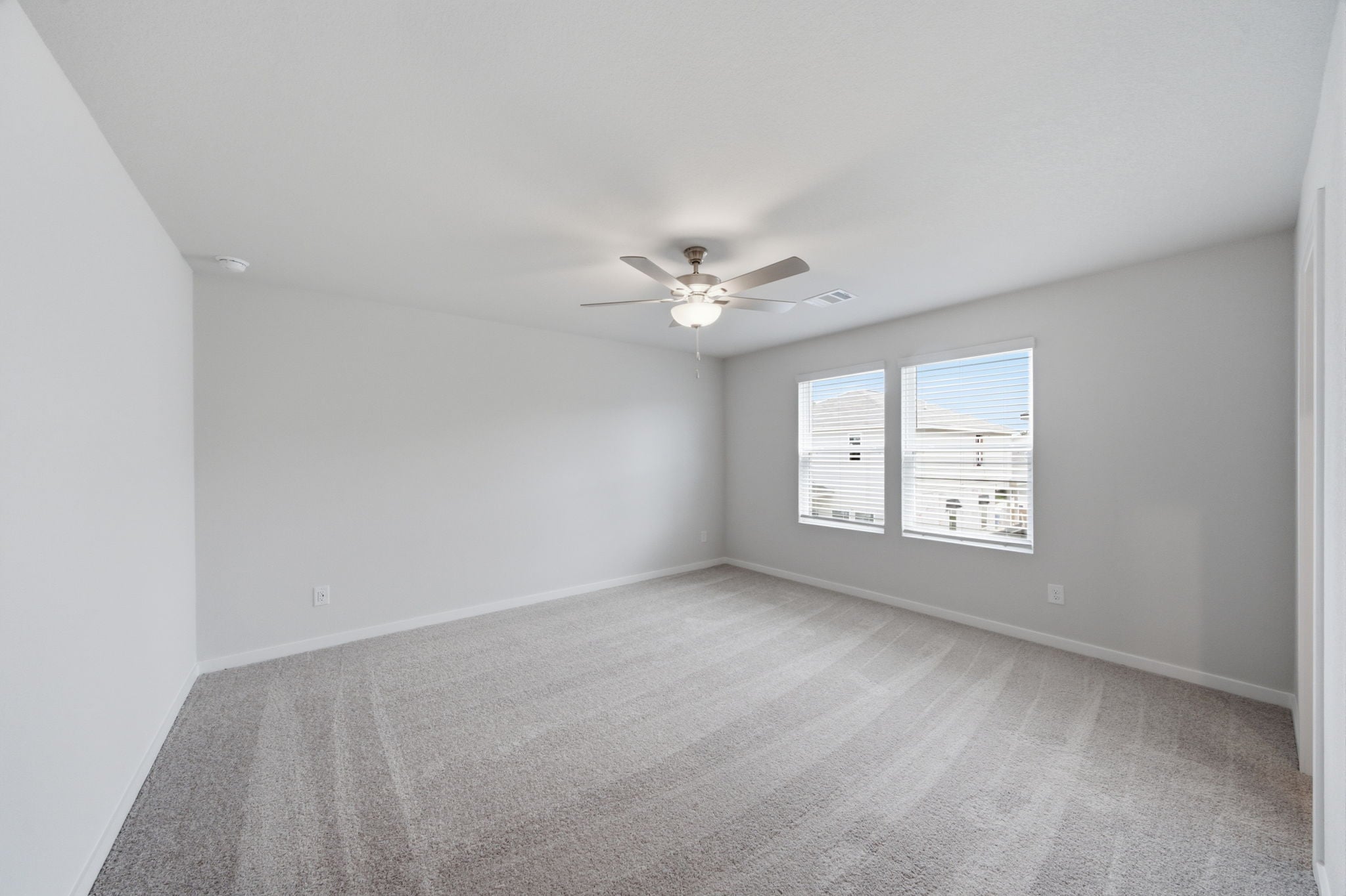 A room with a ceiling fan and a ceiling fan.