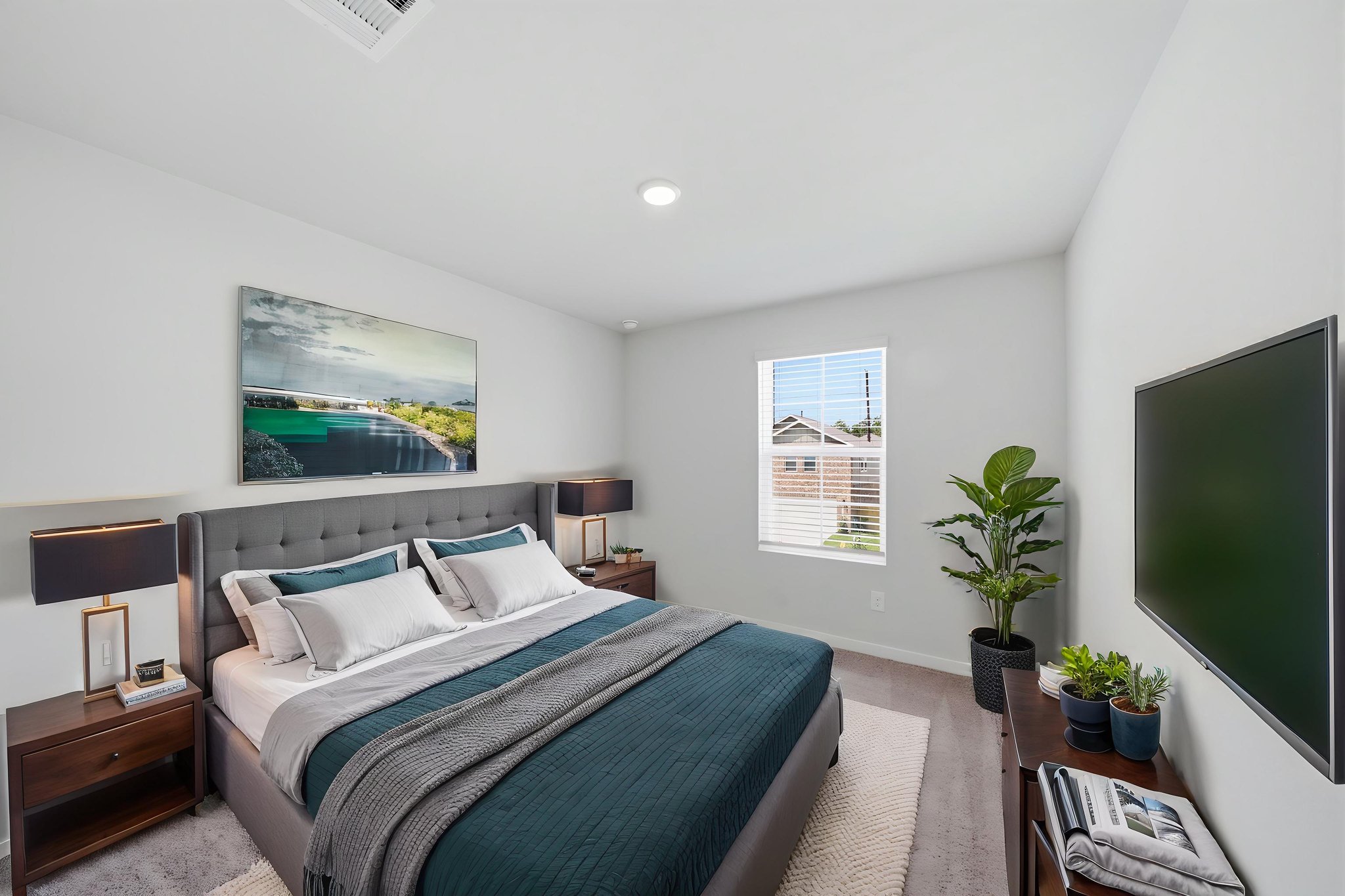 A bedroom with a large television.
