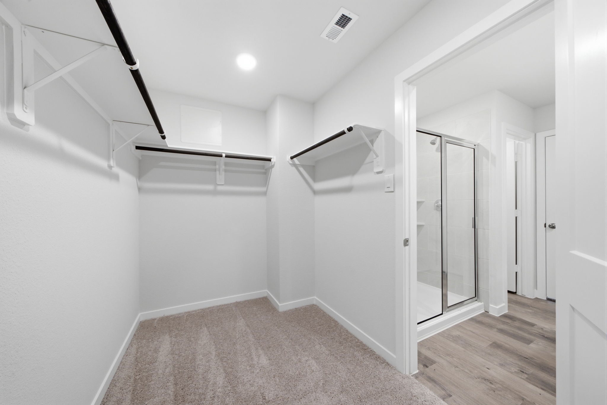 A room with white walls and a wood floor.