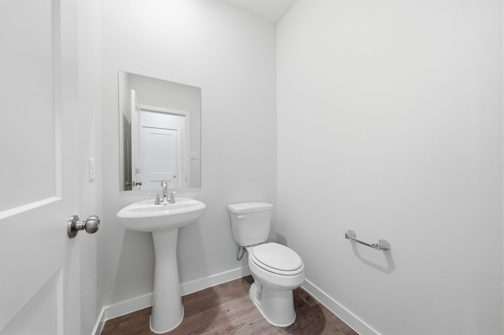 A bathroom with a toilet and sink.