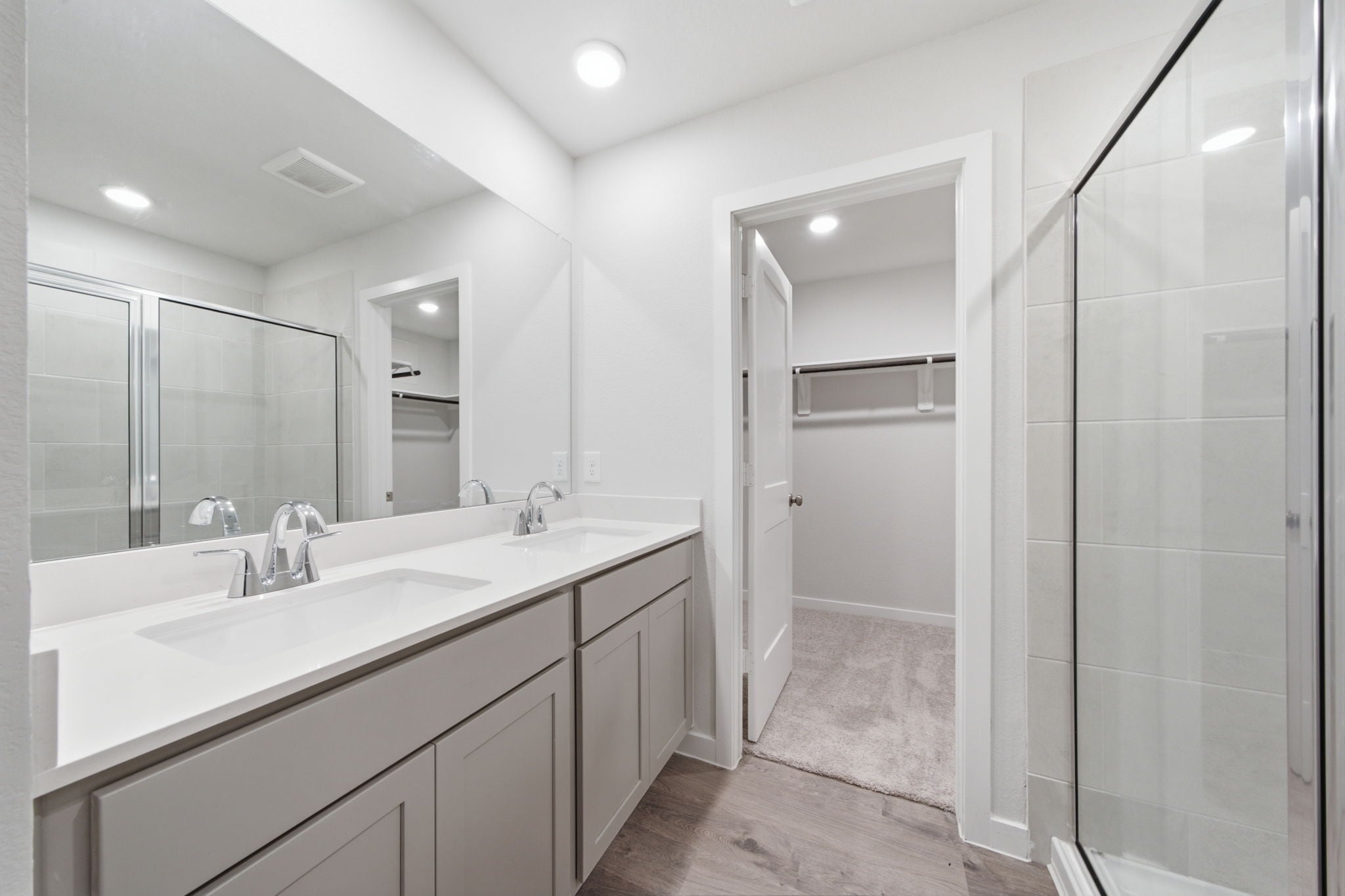 A bathroom with a large mirror.