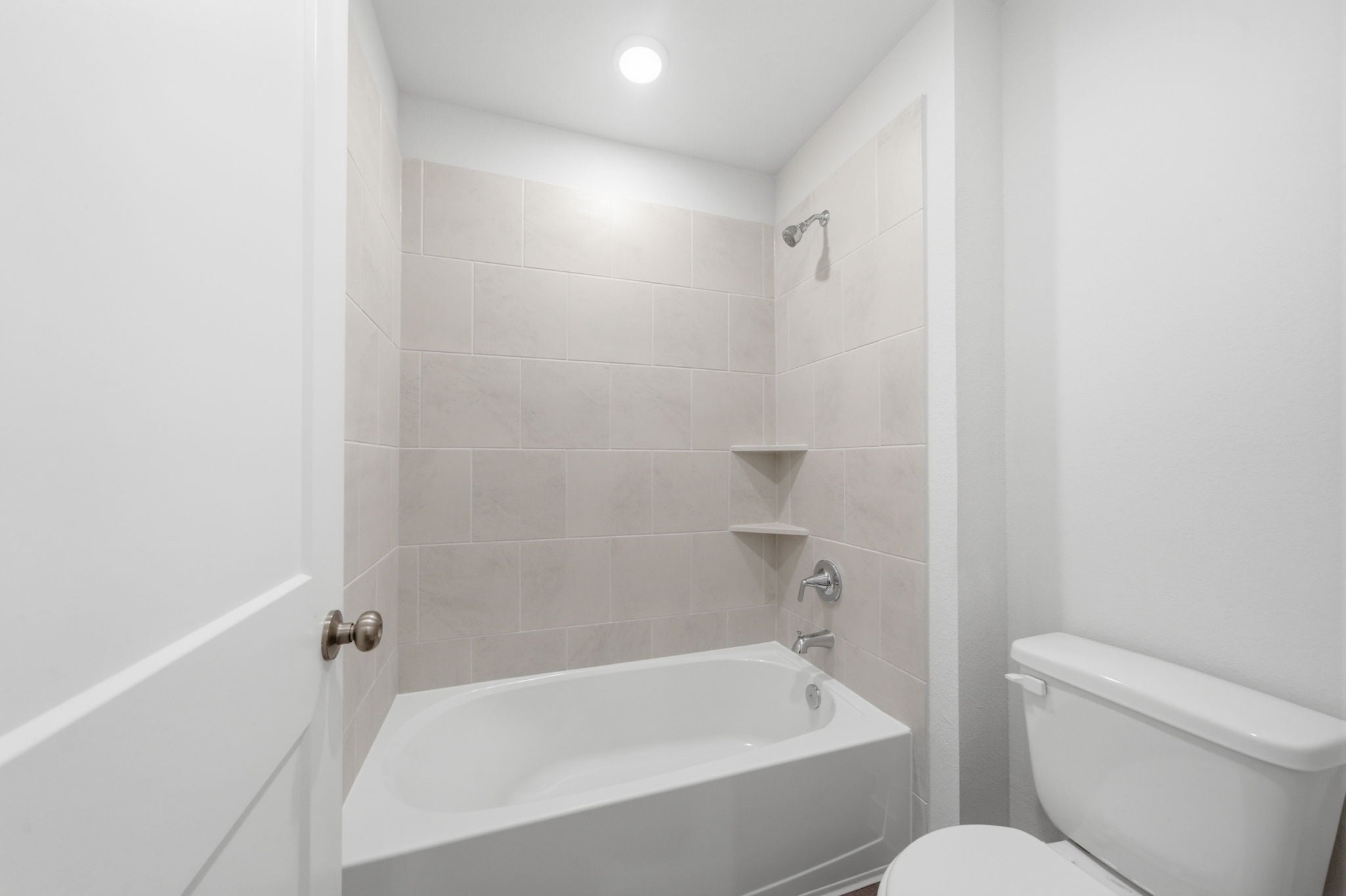 A bathroom with a tub toilet and sink.