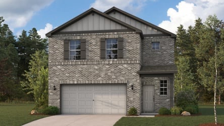 A house with a garage and trees around it.