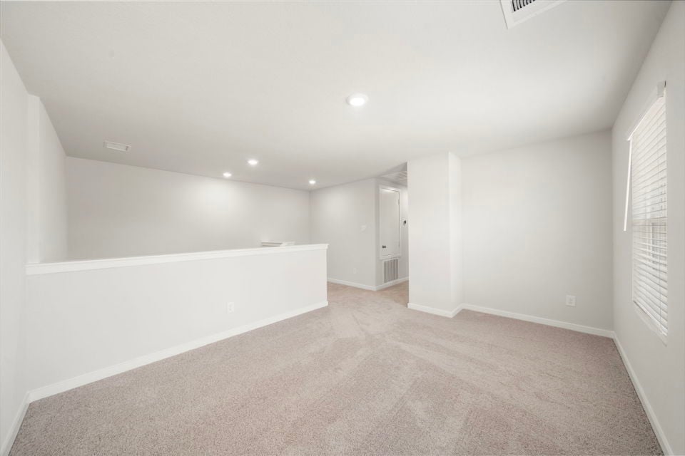 A long hallway with white walls.