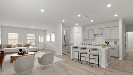 A large living room with a dining table and chairs.