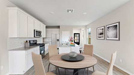 A kitchen with a dining table.