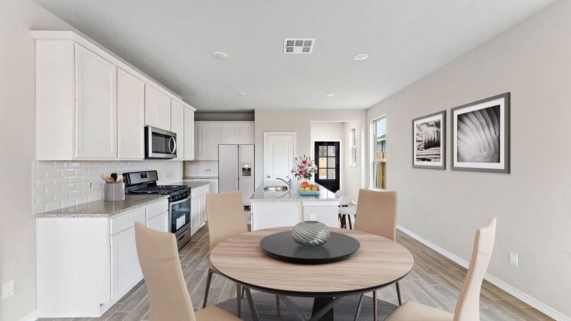 A kitchen with a dining table.