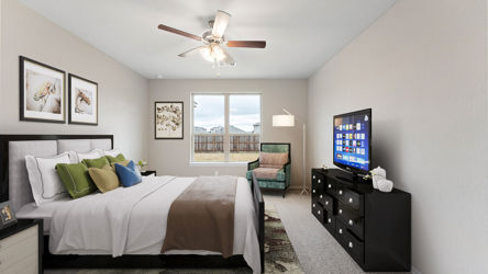 A bedroom with a large window.