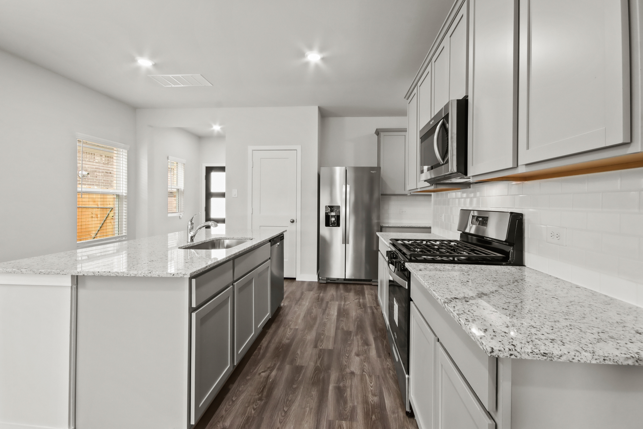 A kitchen with white cabinets.