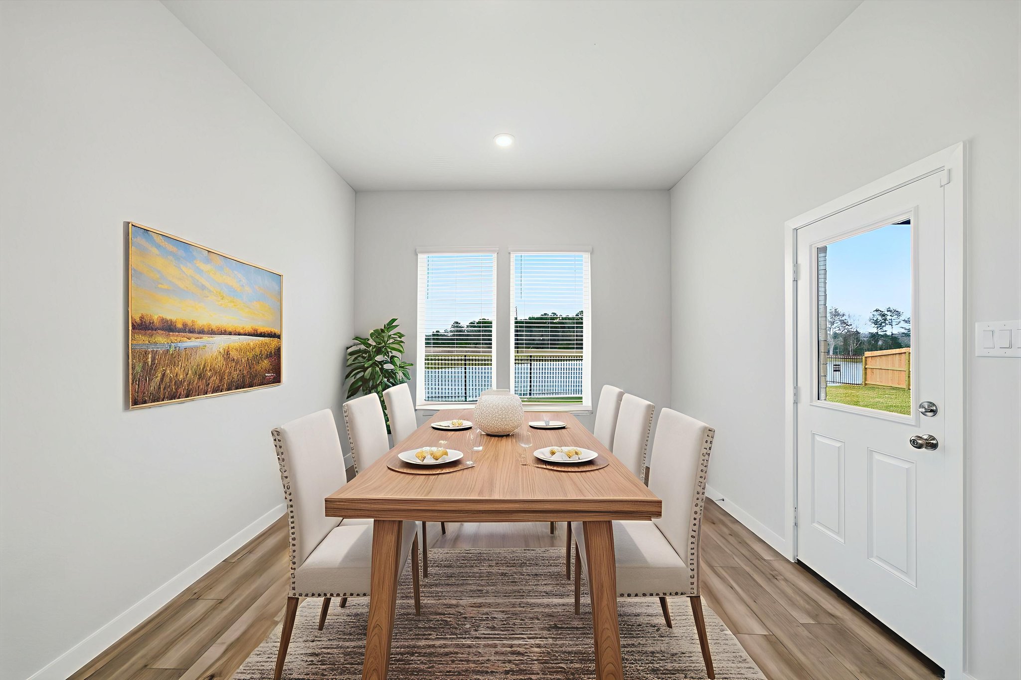 A dining room table with plates and cups on it.