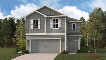 A house with a garage and trees.
