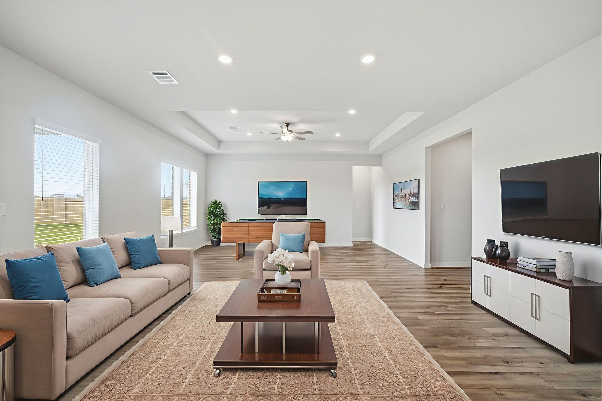 A living room with a large tv and couches.